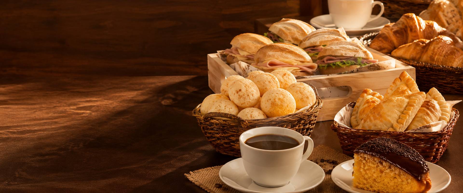 Mesa de café da manhã da Padaria MM: pães de queijo, mini sanduíches, croissants, pastéis e café passado na hora